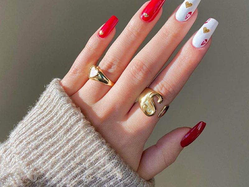 Women's hands with a red manicure. Beautiful woman's hands with ombre gradient nail design. Manicure, pedicure beauty salon concept.