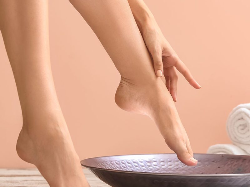 Young woman undergoing spa pedicure treatment in beauty salon